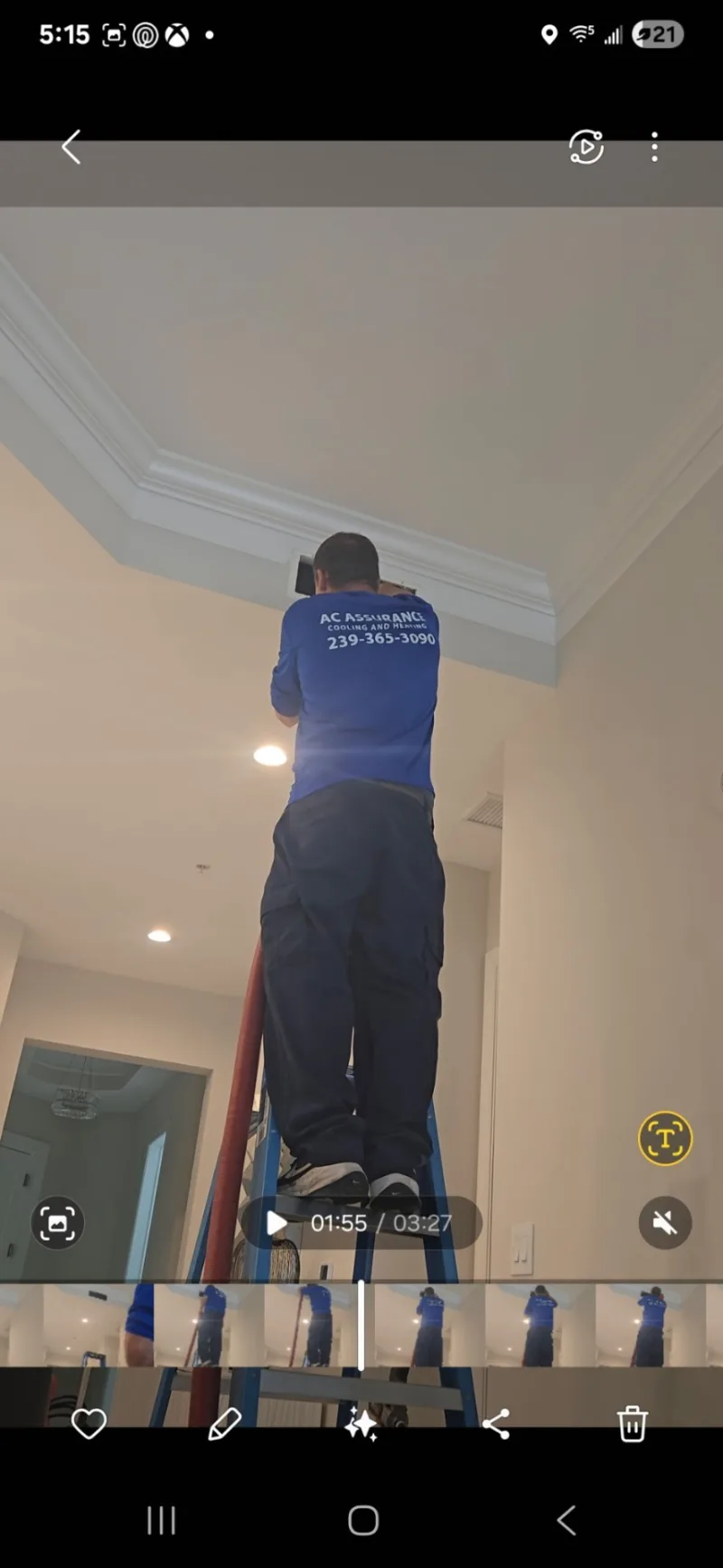 Technician on ladder servicing ceiling vent register