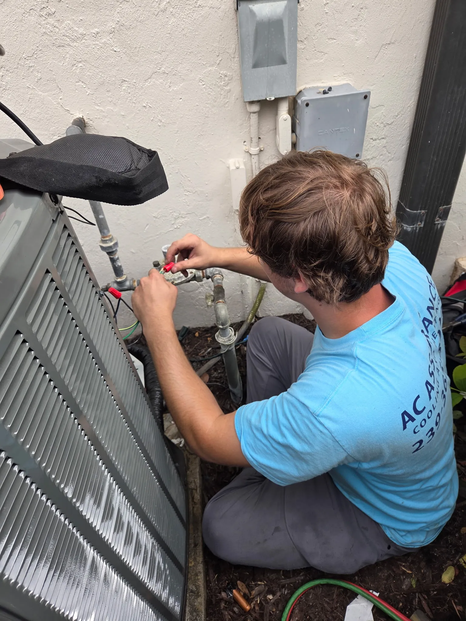 Expert AC repair technician servicing a unit in Cape Coral, FL
